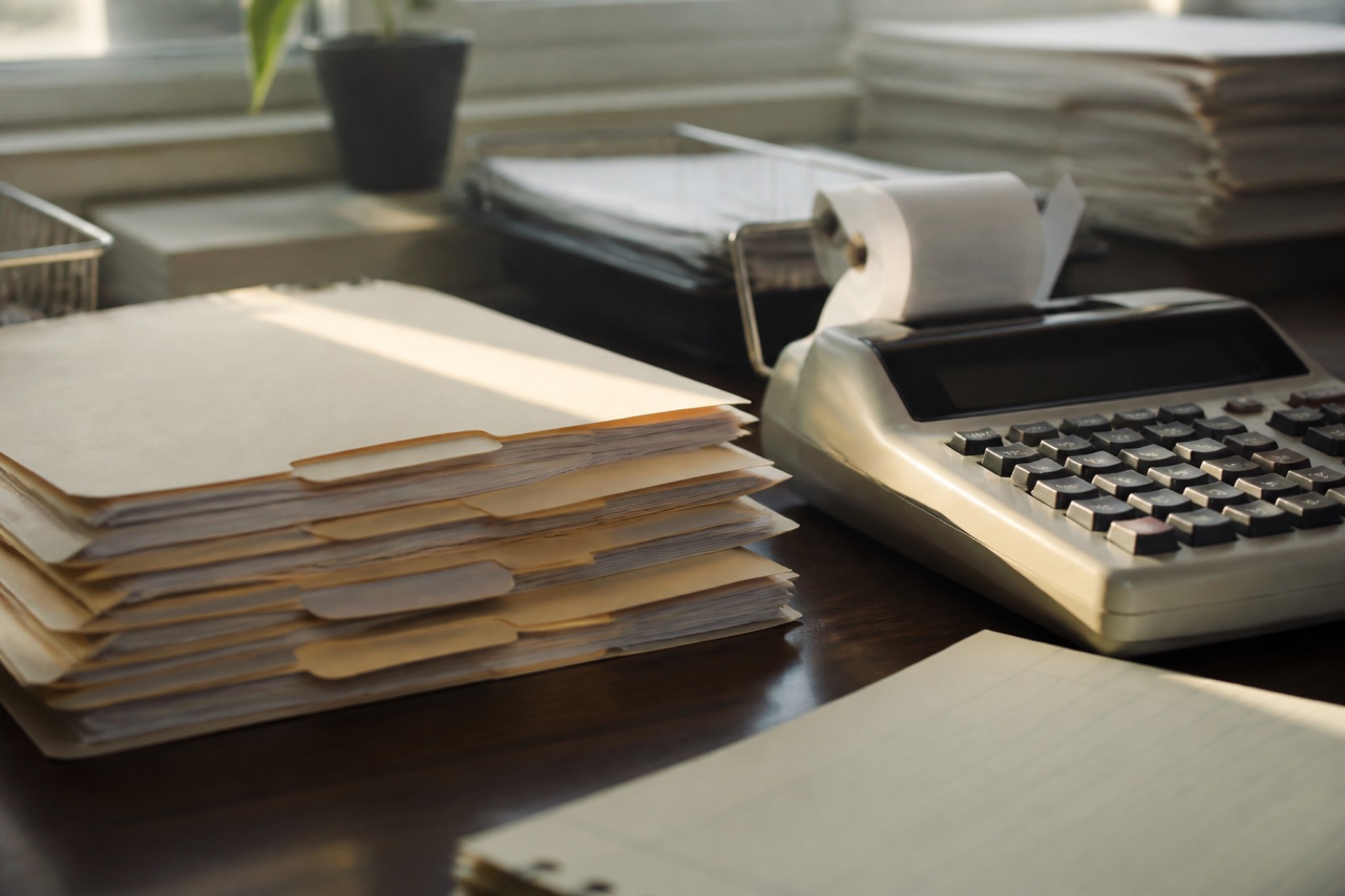 Client file folders and adding machine on an accounting firm desk