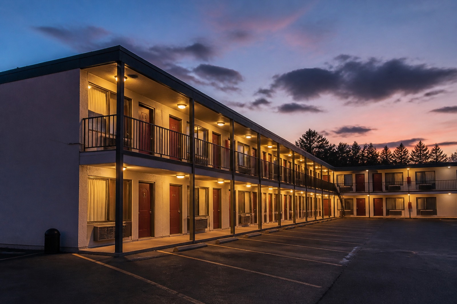 Two story roadside motel at dusk, the property type when buying a motel