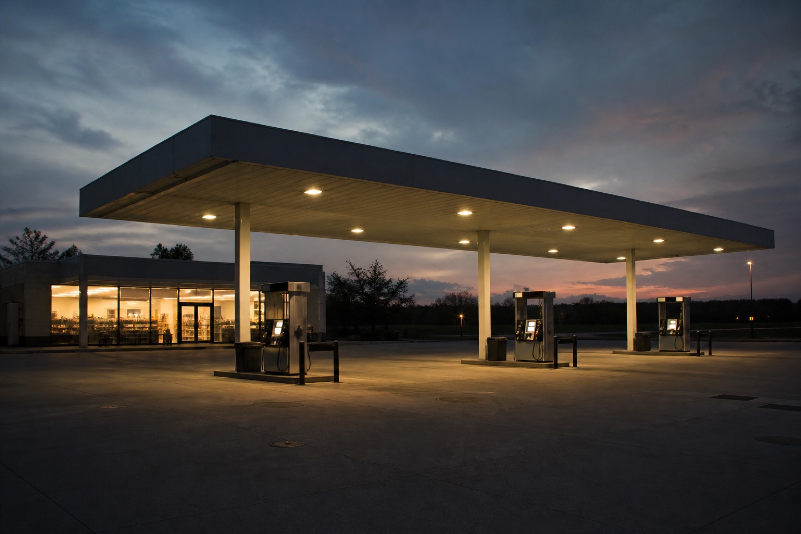 Gas station forecourt at twilight, the branding choice behind how much a gas station is worth