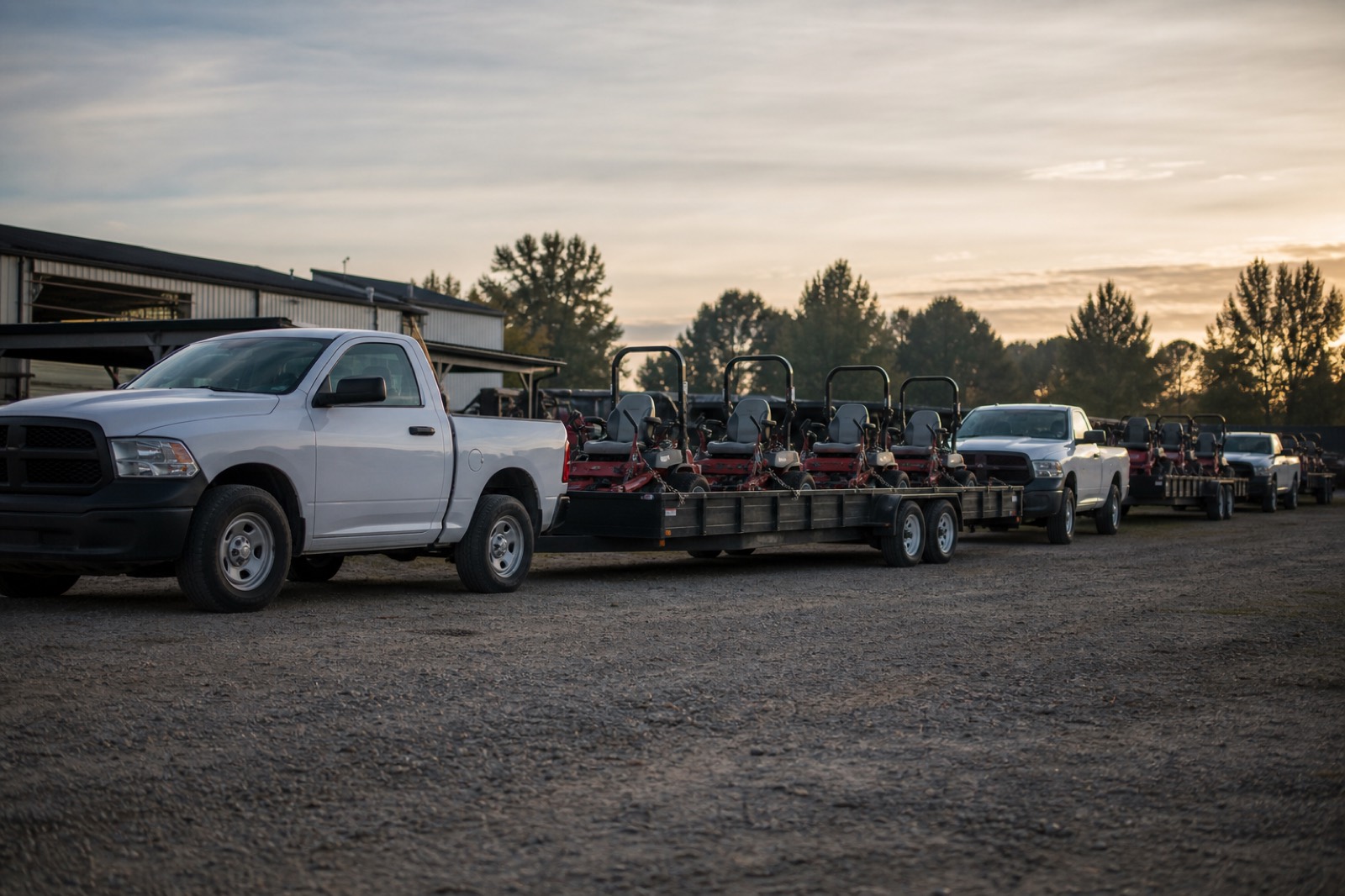 Landscaping company fleet of trucks and mower trailers in an equipment yard