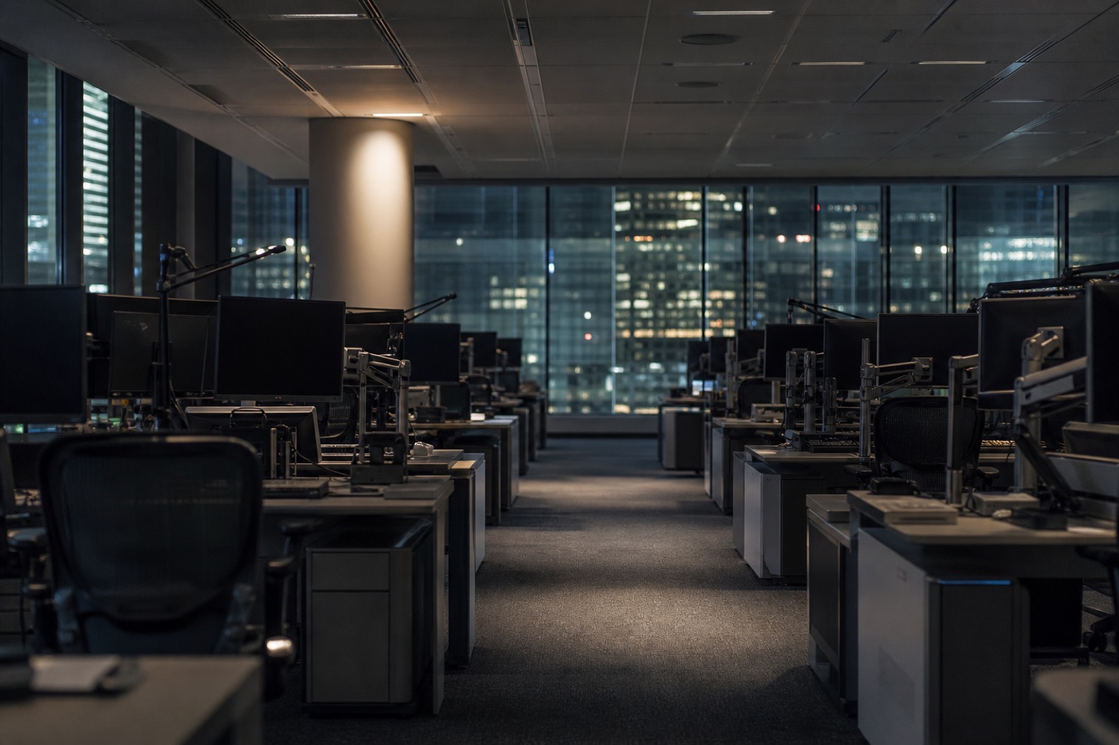 Empty investment bank floor at night, context for M&A league tables
