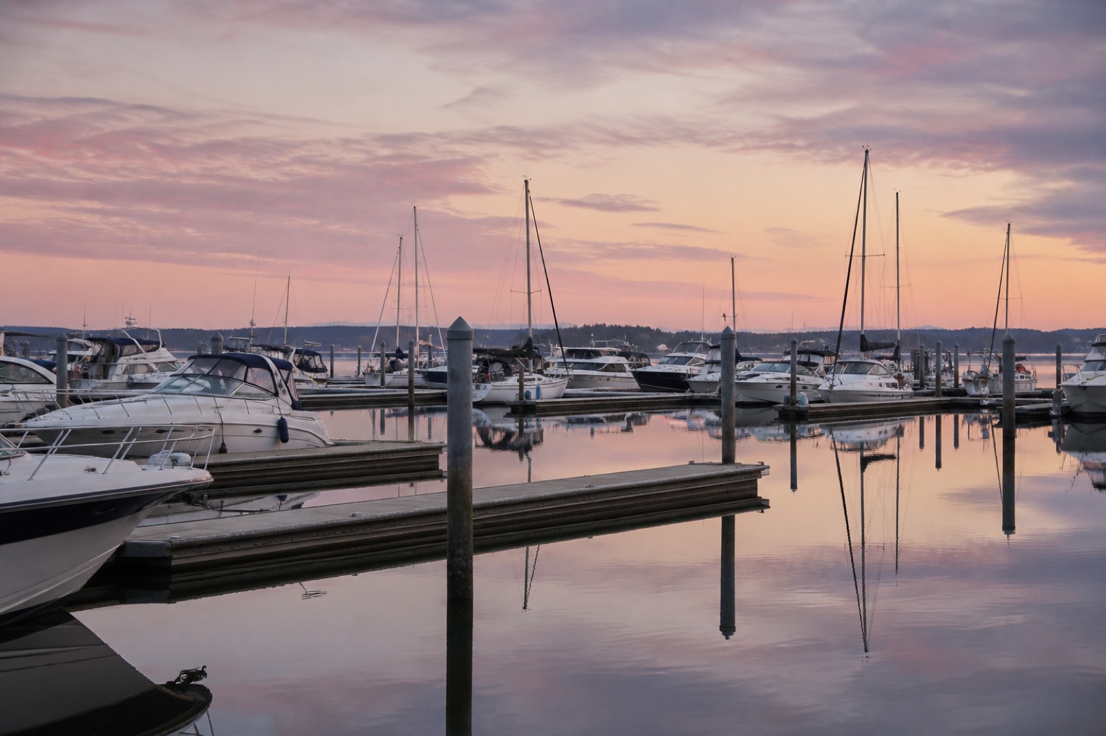 Marina docks at dawn with sailboats and powerboats in slips