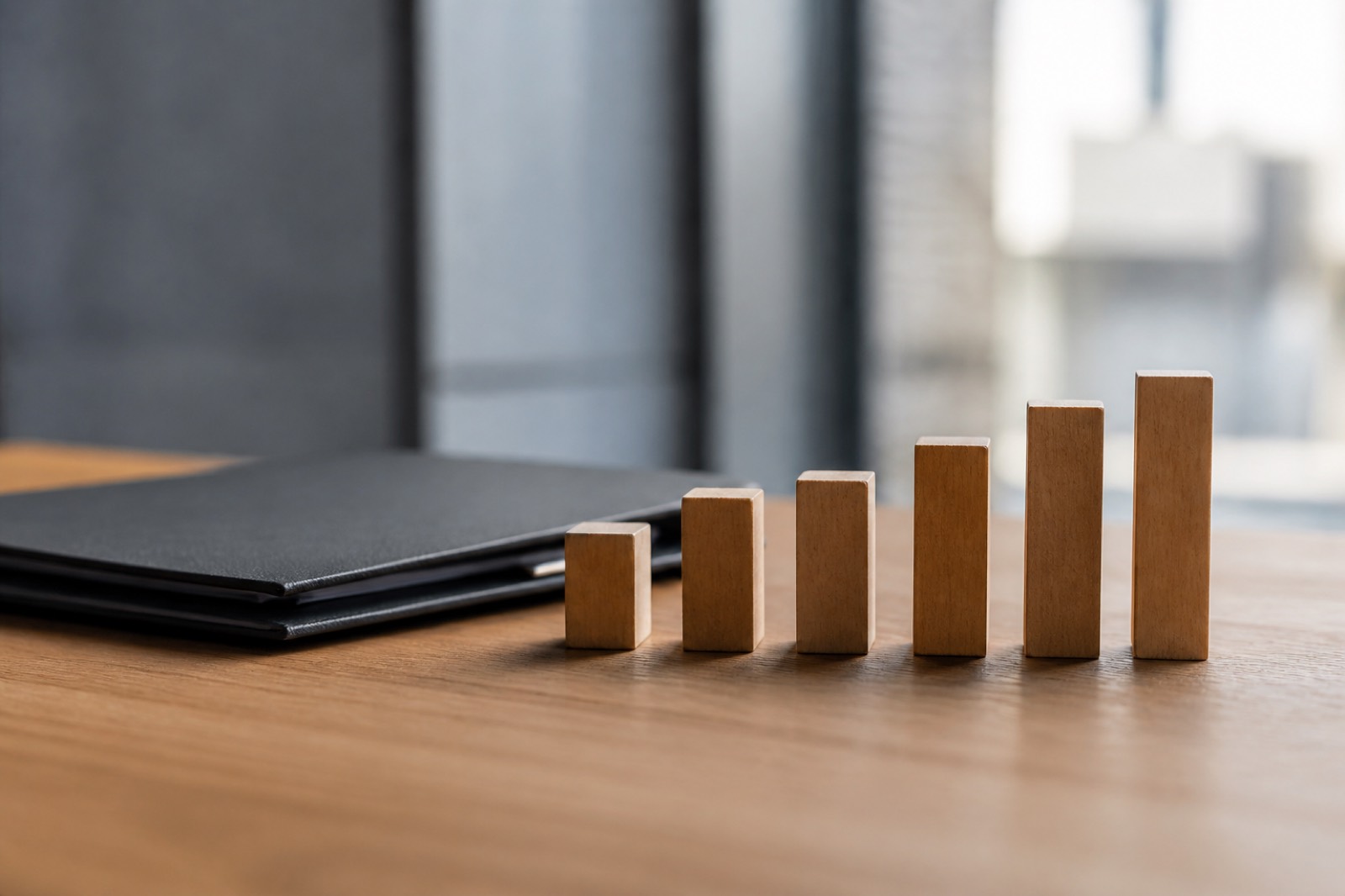 Wooden blocks of different heights representing factors in an SDE valuation multiple