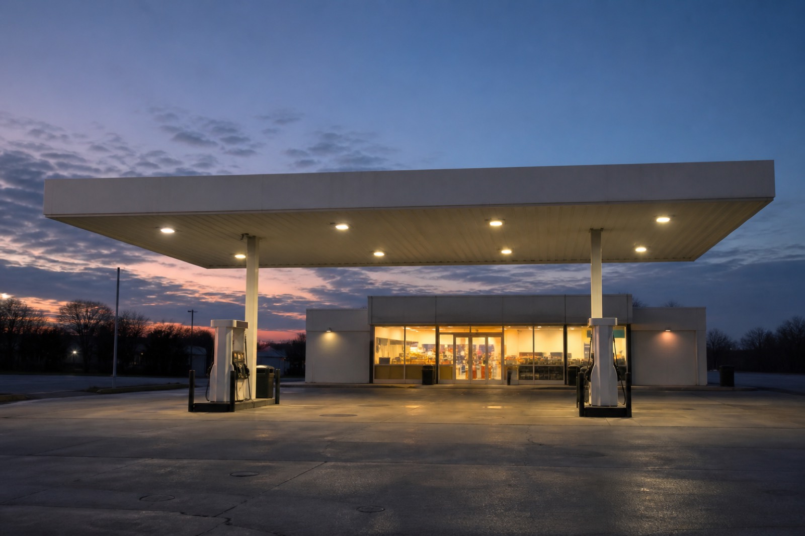 Unbranded gas station at dusk, the site buyers want when you sell a gas station