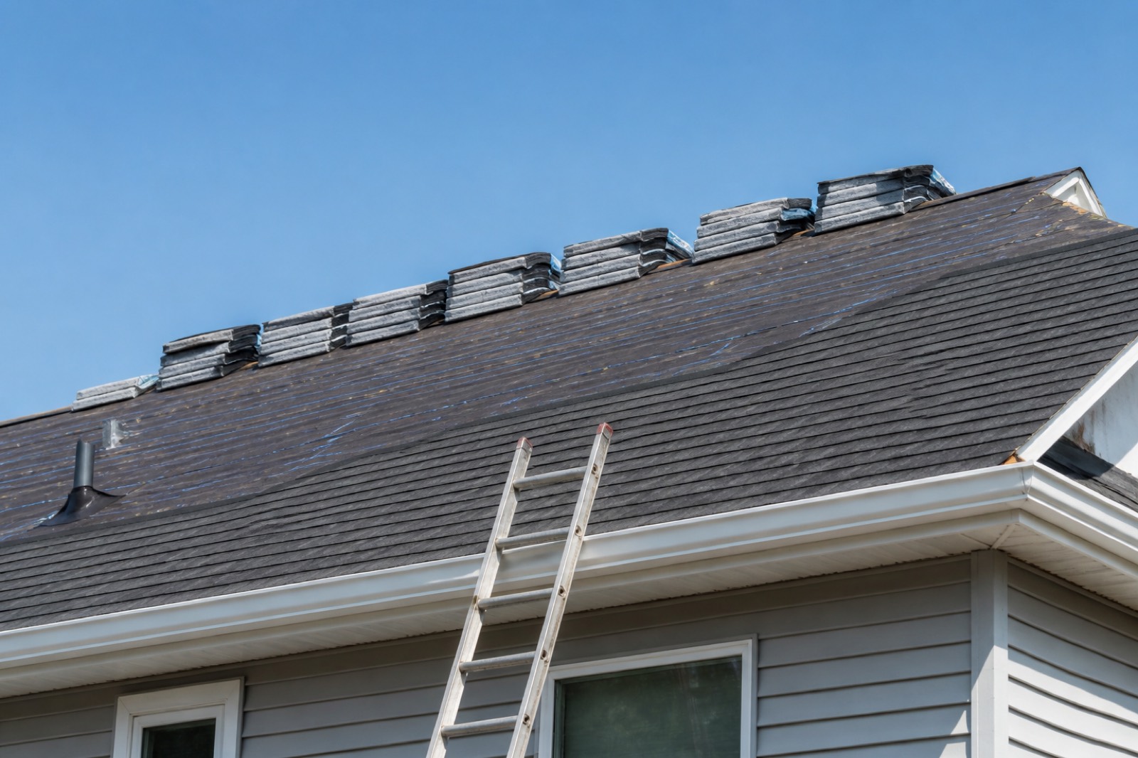Roof under repair with shingle bundles when you sell my roofing company