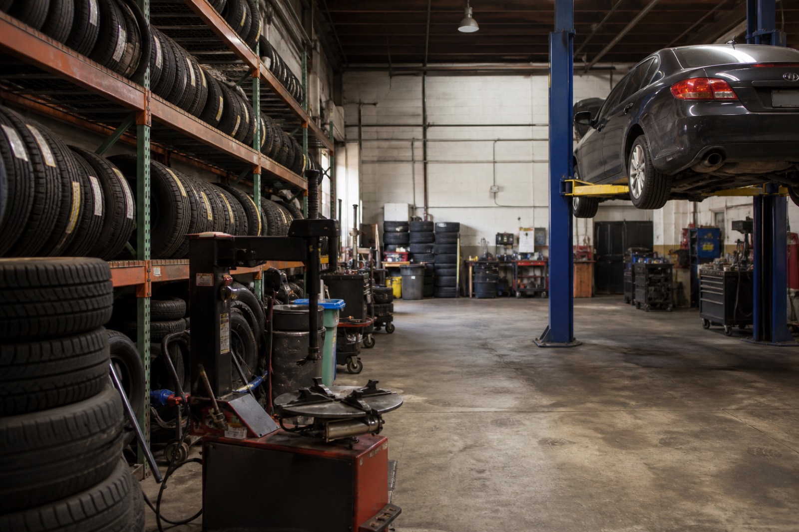 Tire racks and service bays inside a shop when you sell my tire shop